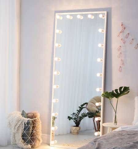 Full length bedroom mirror with lights around it